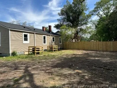 a backyard of a house with table and chairs