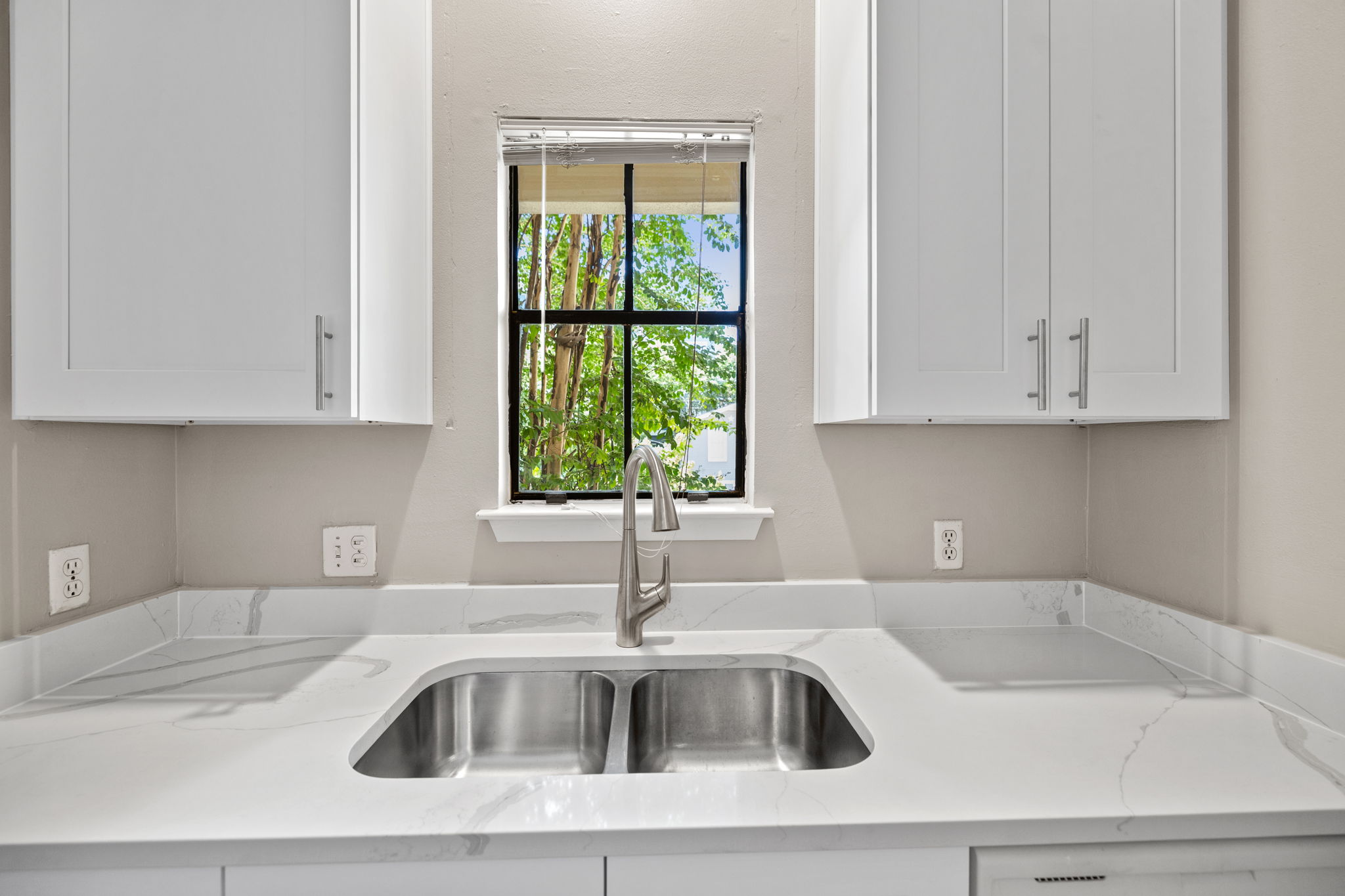 712 Graham Place, Unit 203 Austin, TX 78705 - Photo 8 of 30 a kitchen with a sink cabinets and a window
