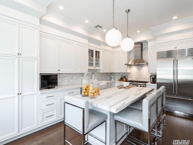 a kitchen with a white cabinets and stainless steel appliances
