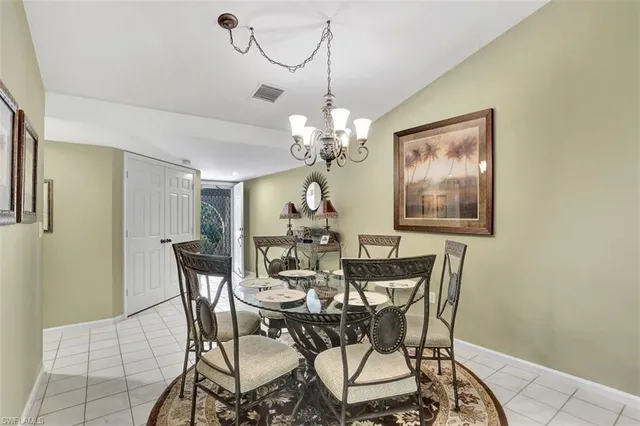 a view of a dining room with furniture and chandelier