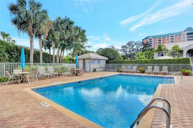 a view of swimming pool with outdoor seating and plants