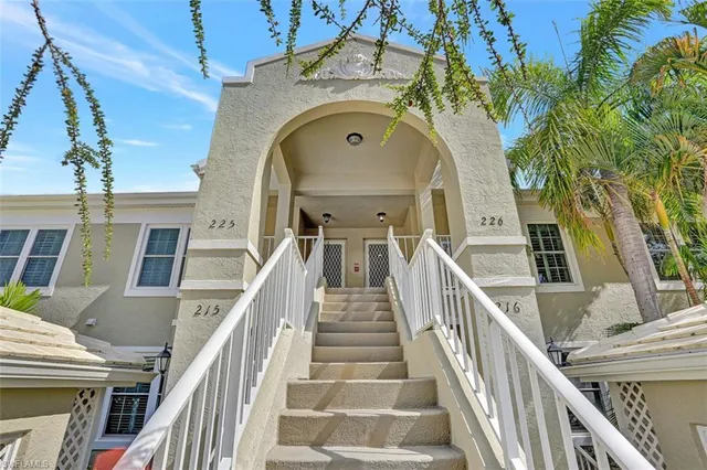 a view of a staircase with lots of frames on wall