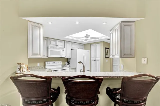 a room with a table chairs and entryway