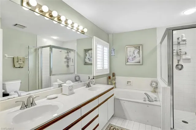 a bathroom with a tub double sink and mirror