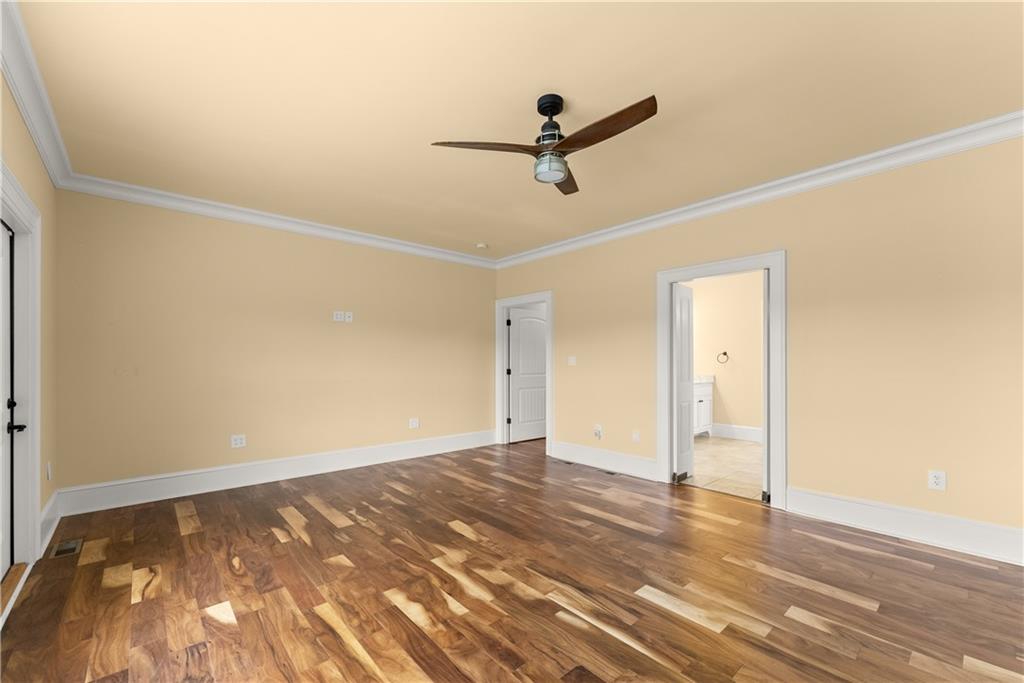 725 County Farm Road Jefferson, GA 30549 - Photo 25 of 66 a view of a room with wooden floor and ceiling fan