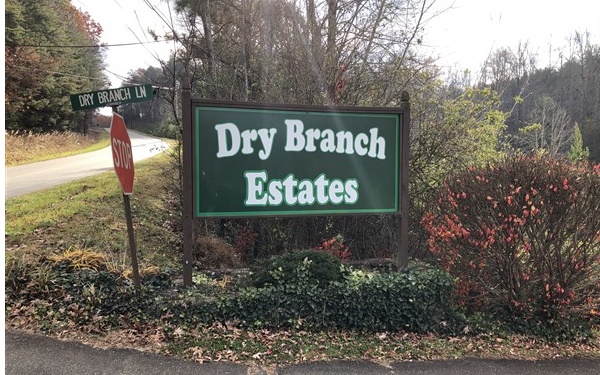 a sign broad in front of the red brick house