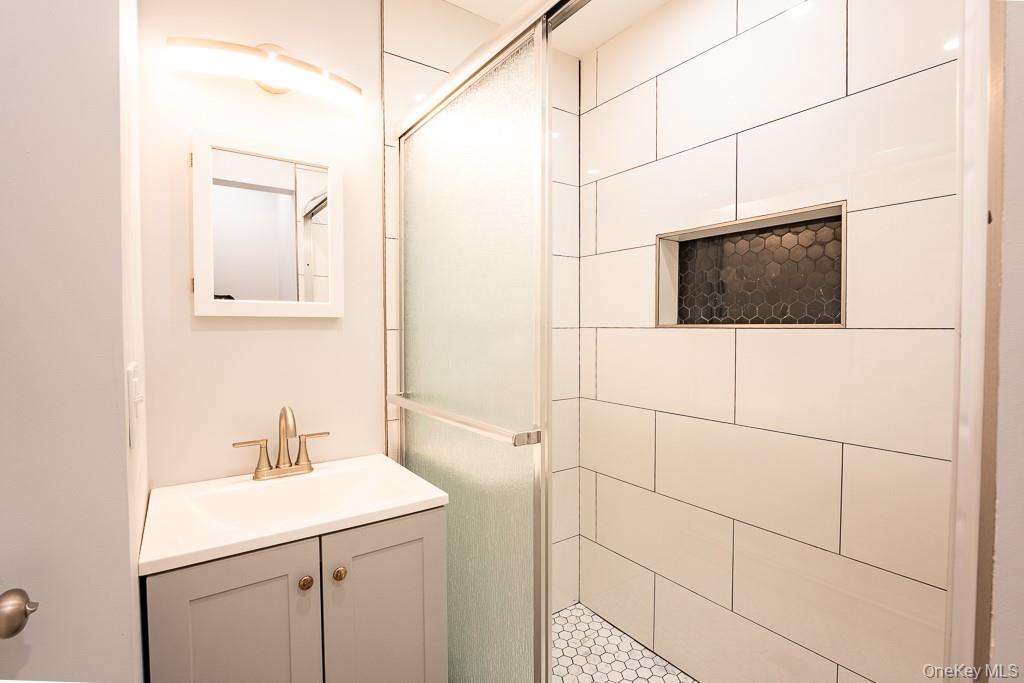 25 Robin Road Poughkeepsie, NY 12601 - Photo 16 of 37 a bathroom with a sink a toilet and mirror