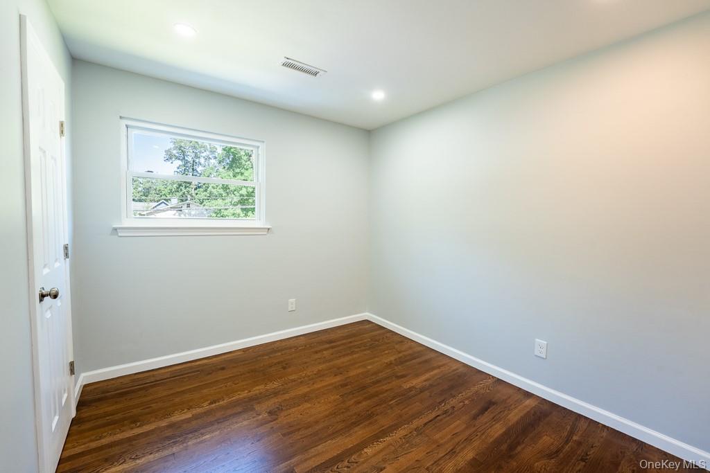 25 Robin Road Poughkeepsie, NY 12601 - Photo 26 of 37 an empty room with wooden floor and windows