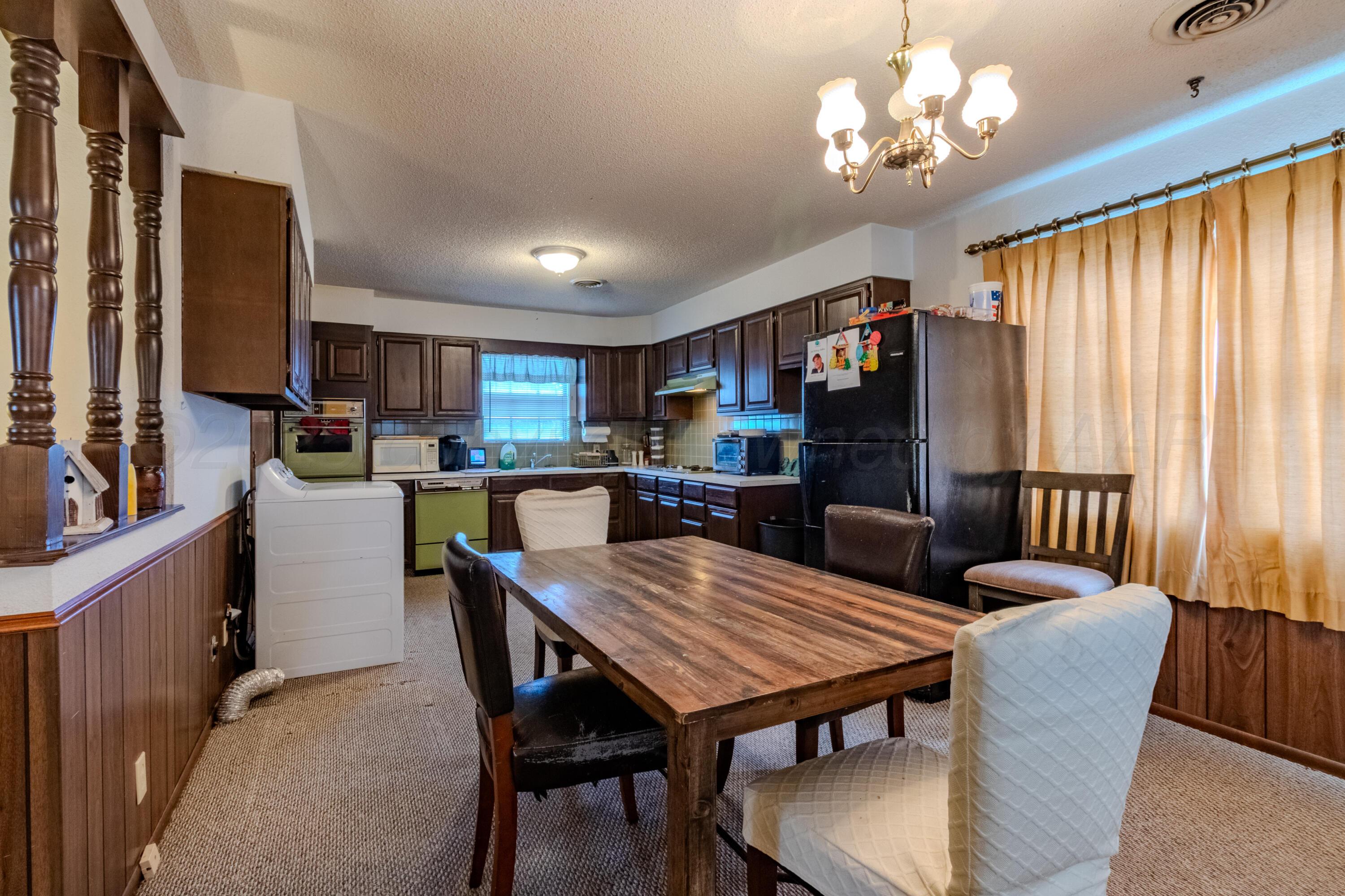 103 Jefferson Street Skellytown, TX 79080 - Photo 12 of 35 a view of a dining room with furniture window and wooden floor