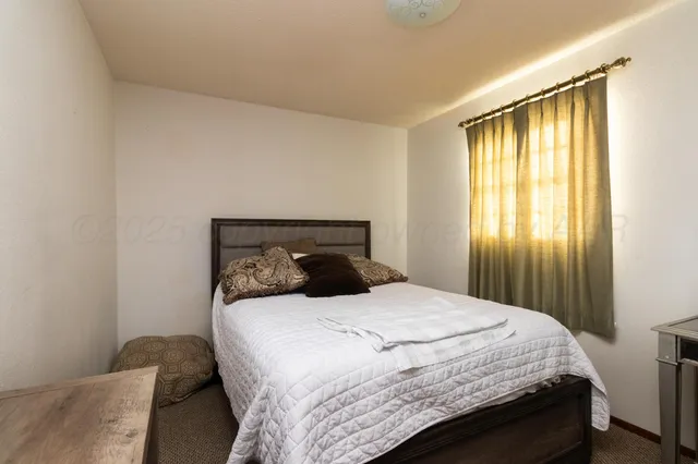 a bedroom with a bed and a dresser