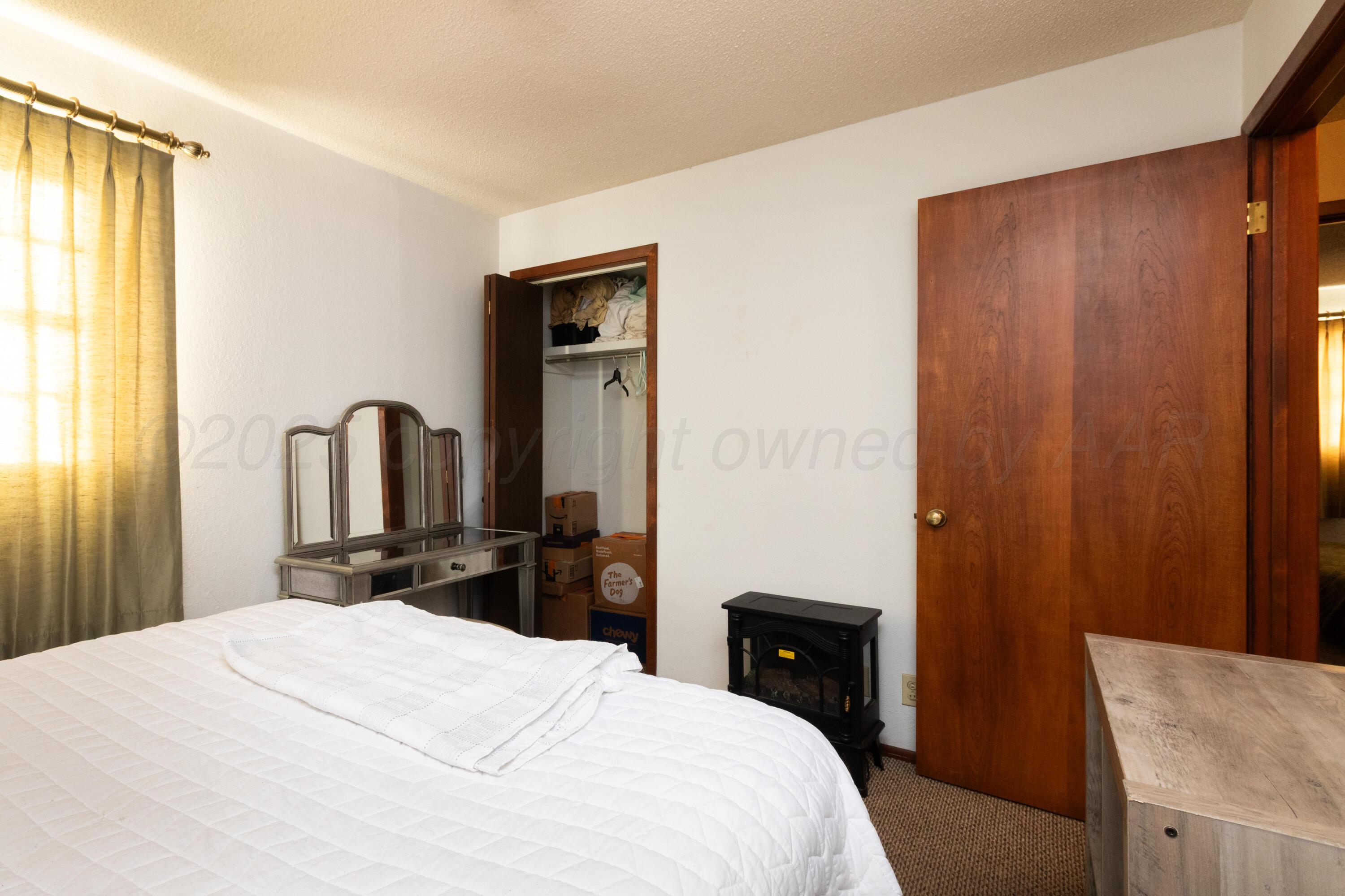 103 Jefferson Street Skellytown, TX 79080 - Photo 19 of 35 a bedroom with a bed and a dresser