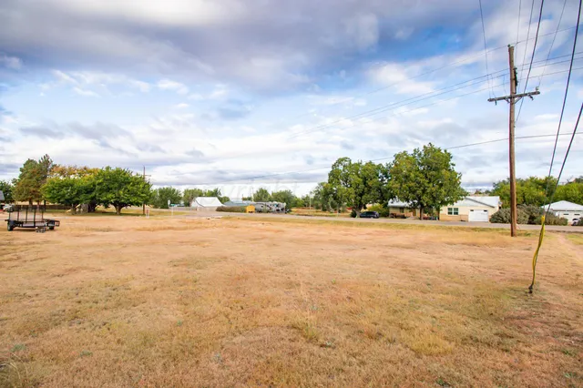 a front view of house with yard and car parked