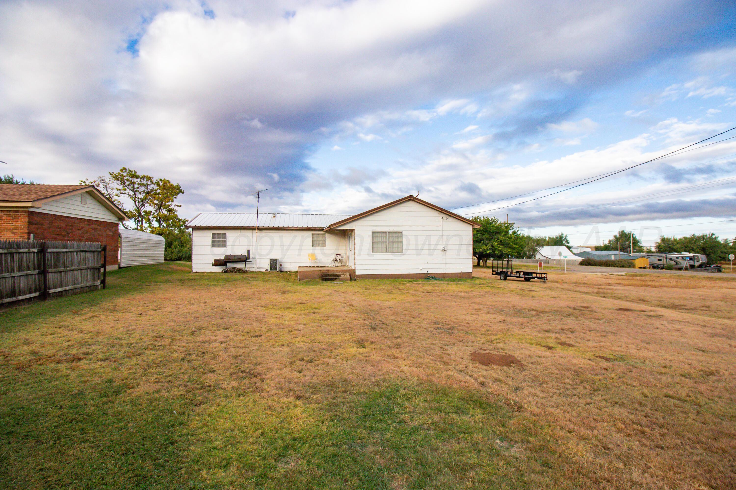 103 Jefferson Street Skellytown, TX 79080 - Photo 29 of 35 a front view of a house with a yard and garage