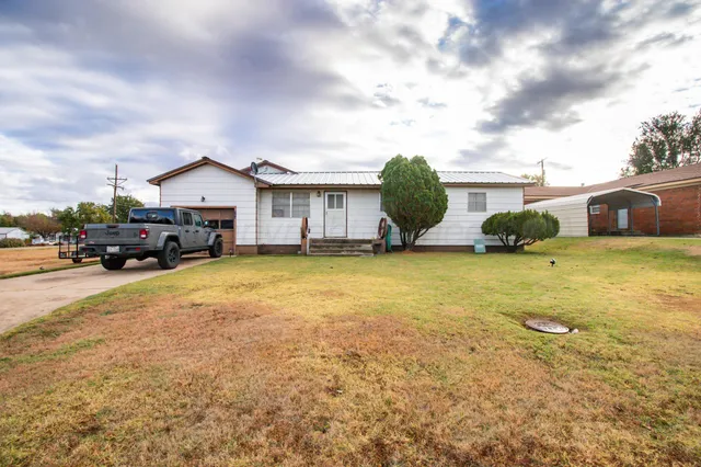 a view of a house with cars parked in front of a house