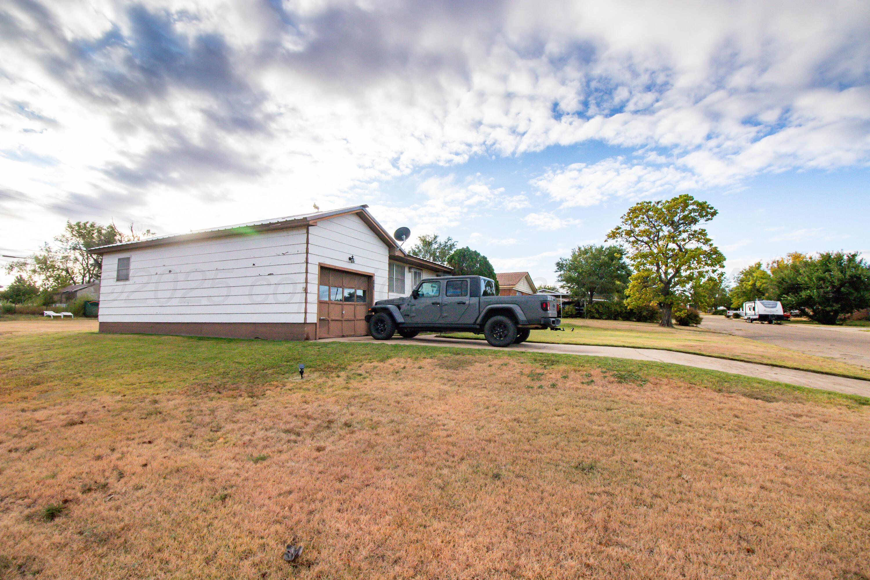 103 Jefferson Street Skellytown, TX 79080 - Photo 6 of 35 a front view of a house with a yard