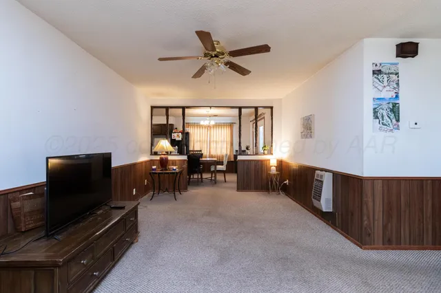 a view of a dining room with furniture and a chandelier