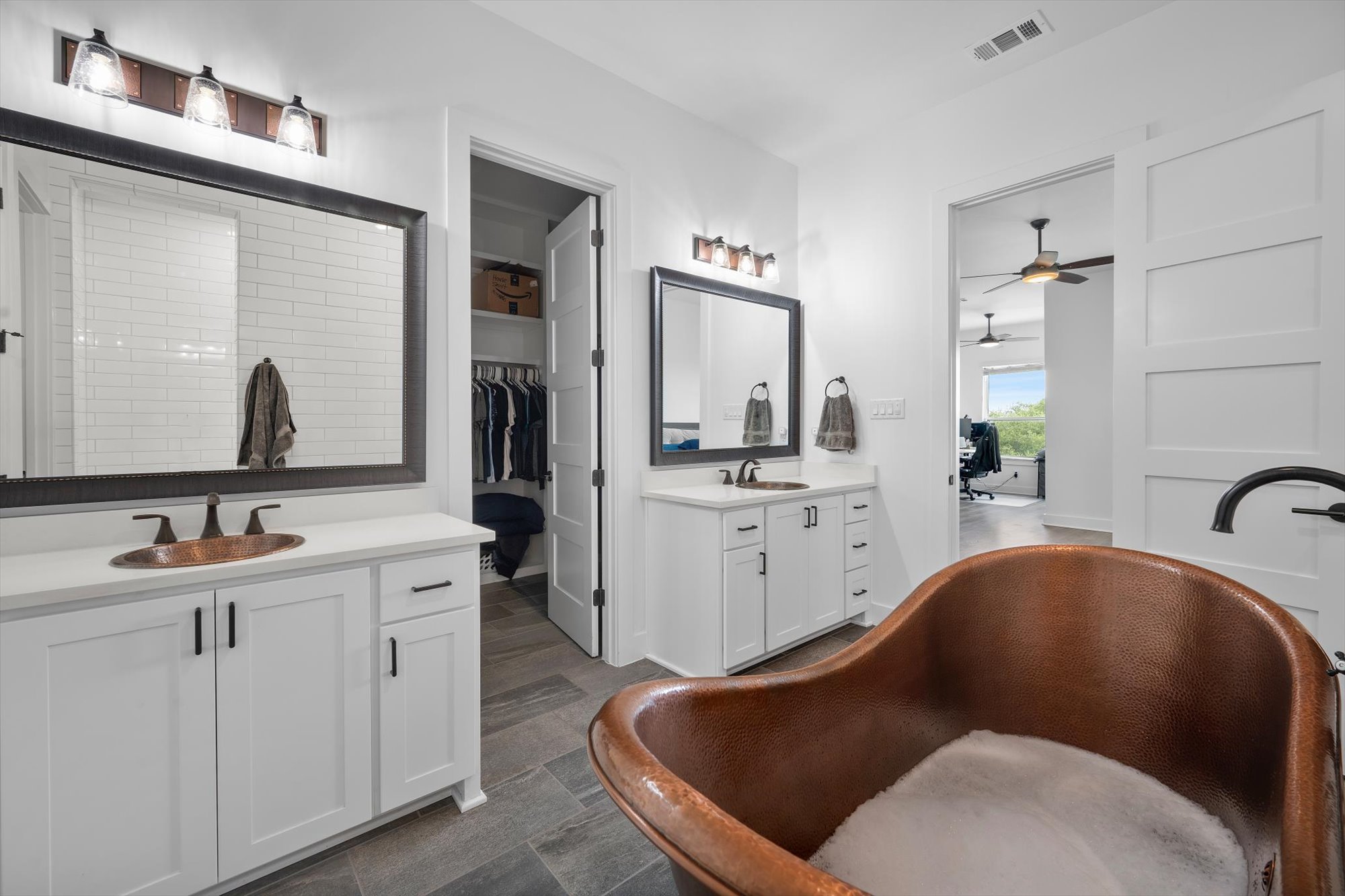 638 Strada Luca Florence, TX 76527 - Photo 15 of 38 Luxurious master bathroom with dual vanities, copper soaking tub, and walk-in closet access.