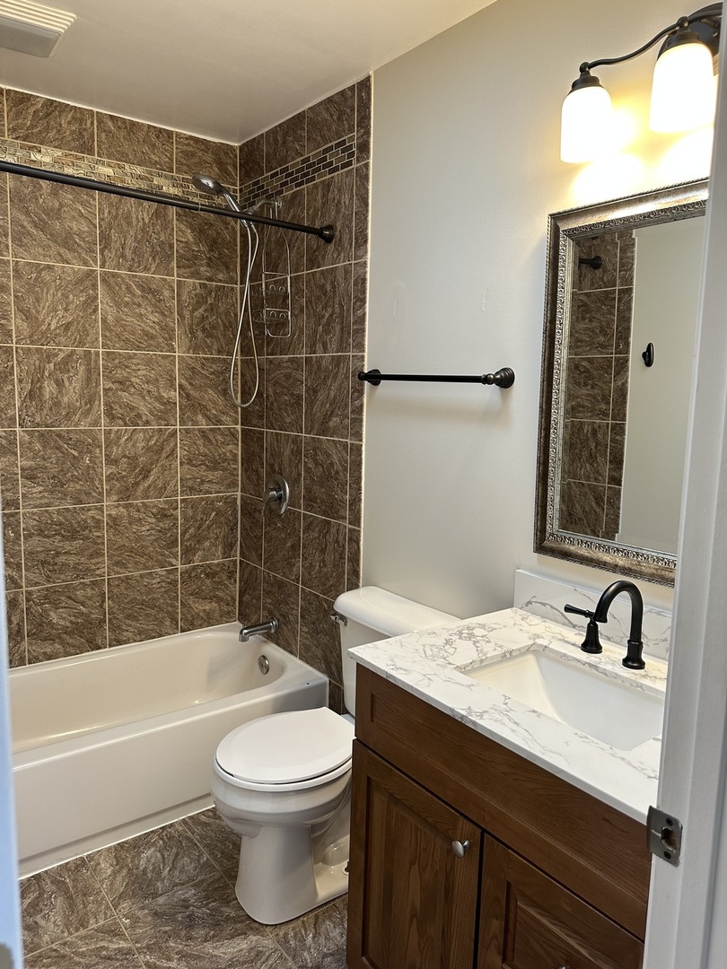 1691 Bilter Road Aurora, IL 60502 - Photo 7 of 19 a bathroom with a sink a toilet and shower