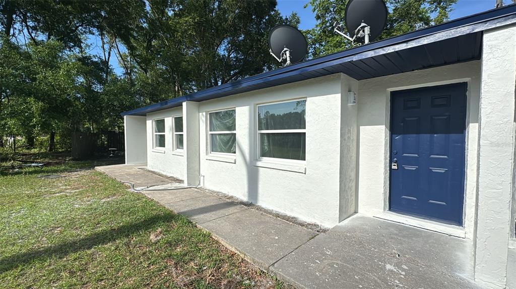836 Southwest 64th Terrace, Unit B Gainesville, FL 32607 - Photo 2 of 13 a view of a house with a yard and garage