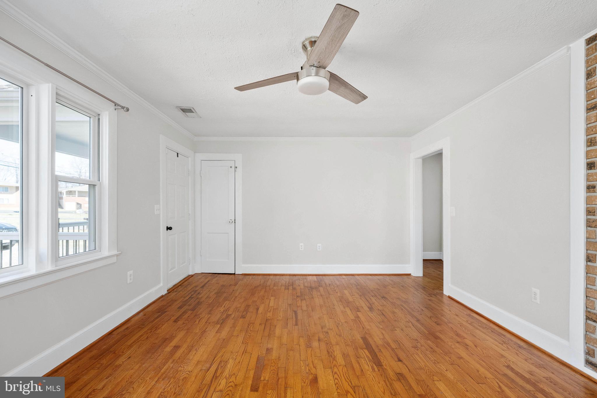 246 Berry Street Orange, VA 22960 - Photo 13 of 46 a view of empty room with wooden floor and fan
