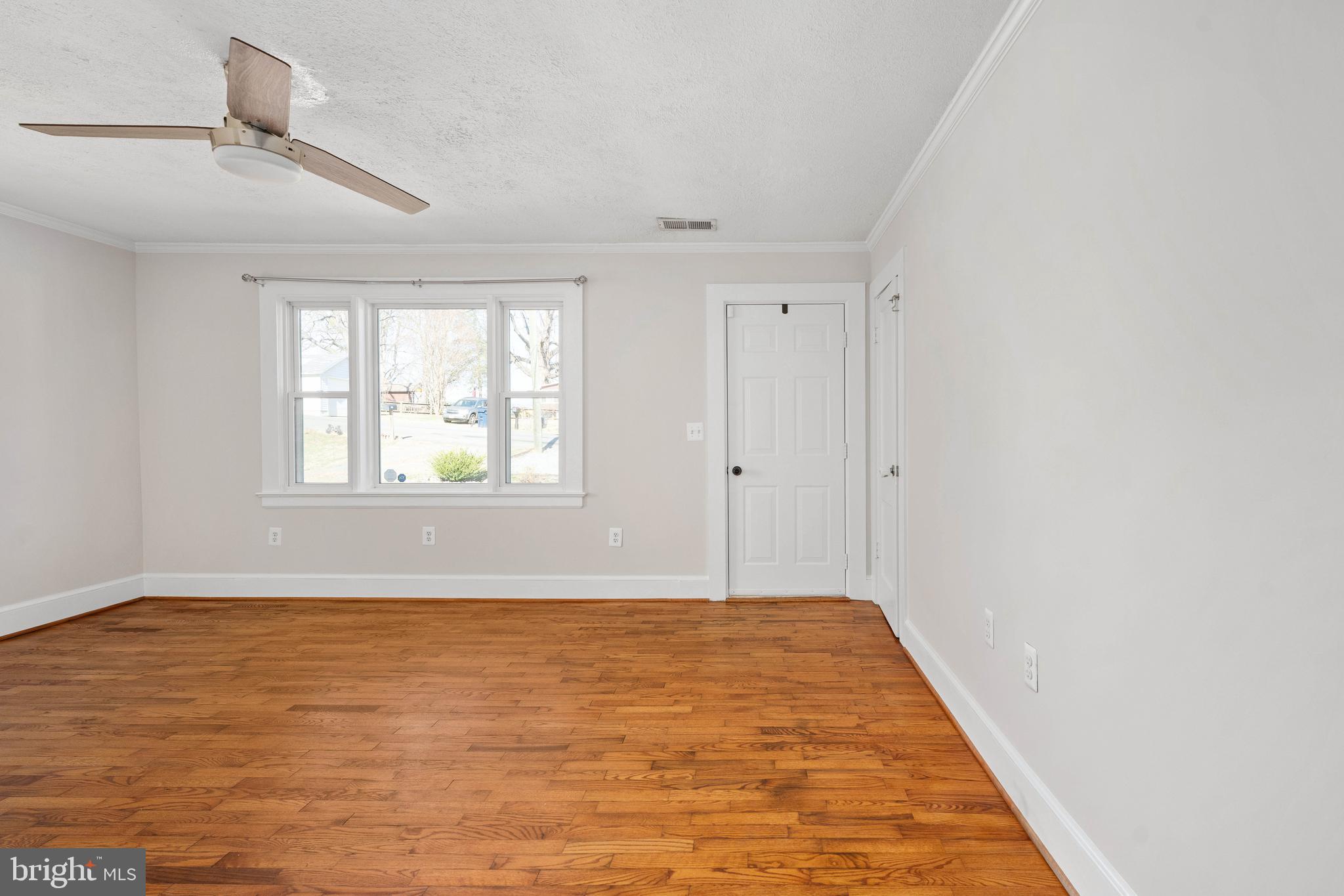 246 Berry Street Orange, VA 22960 - Photo 15 of 46 a view of an empty room with wooden floor and a window