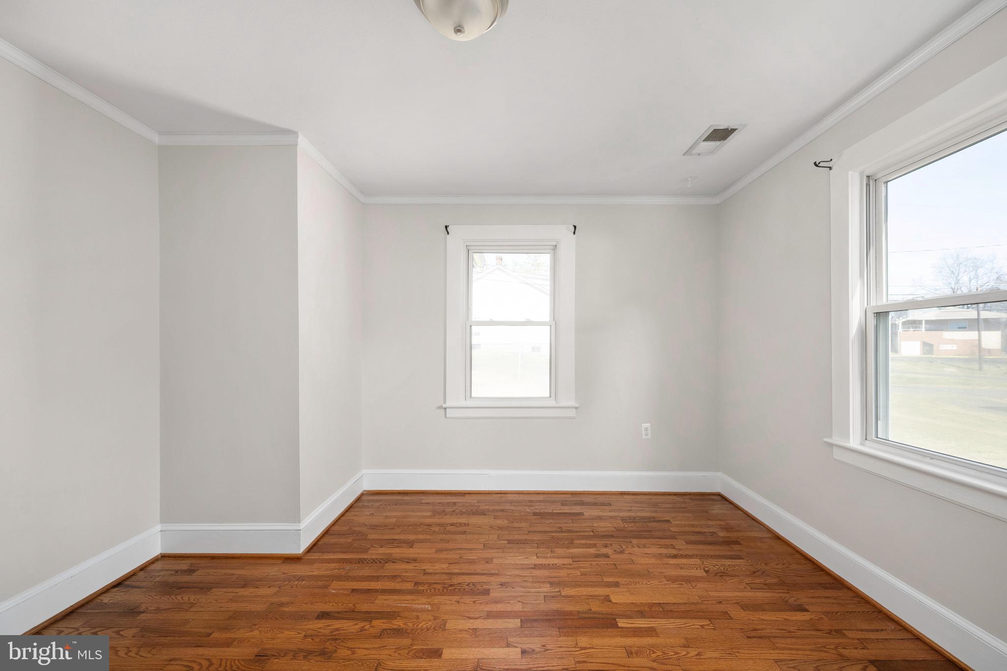 246 Berry Street Orange, VA 22960 - Photo 17 of 46 a view of an empty room with wooden floor and a window