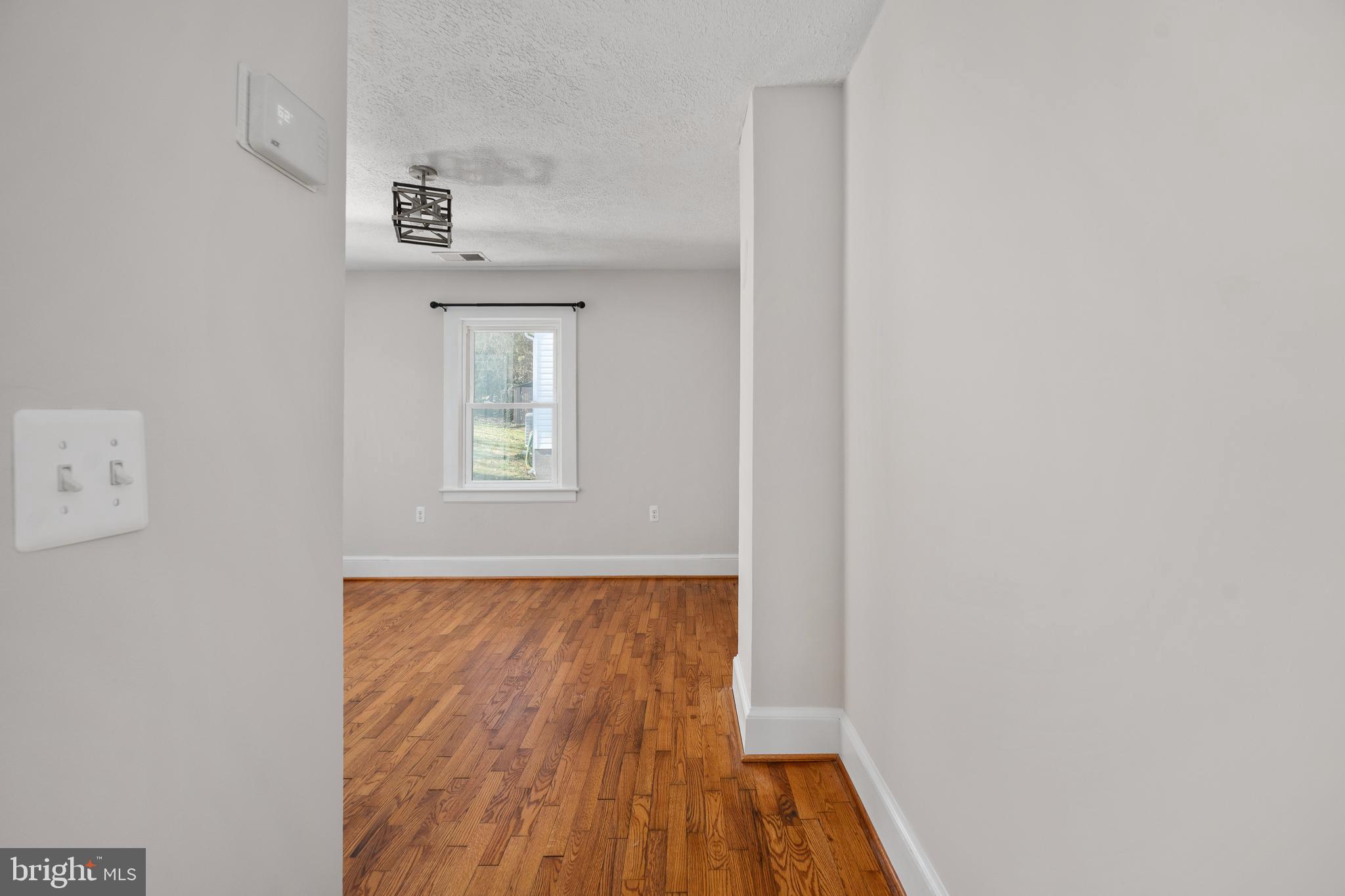246 Berry Street Orange, VA 22960 - Photo 24 of 46 a view of a hallway with wooden floor and a window
