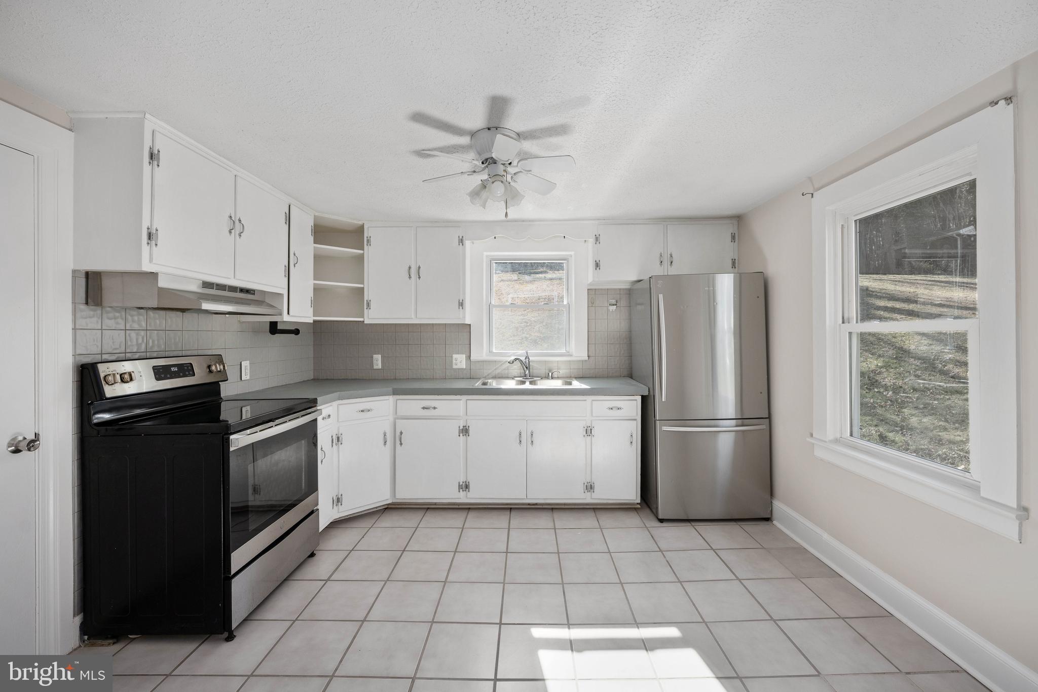 246 Berry Street Orange, VA 22960 - Photo 29 of 46 a kitchen with a white cabinets stove and refrigerator