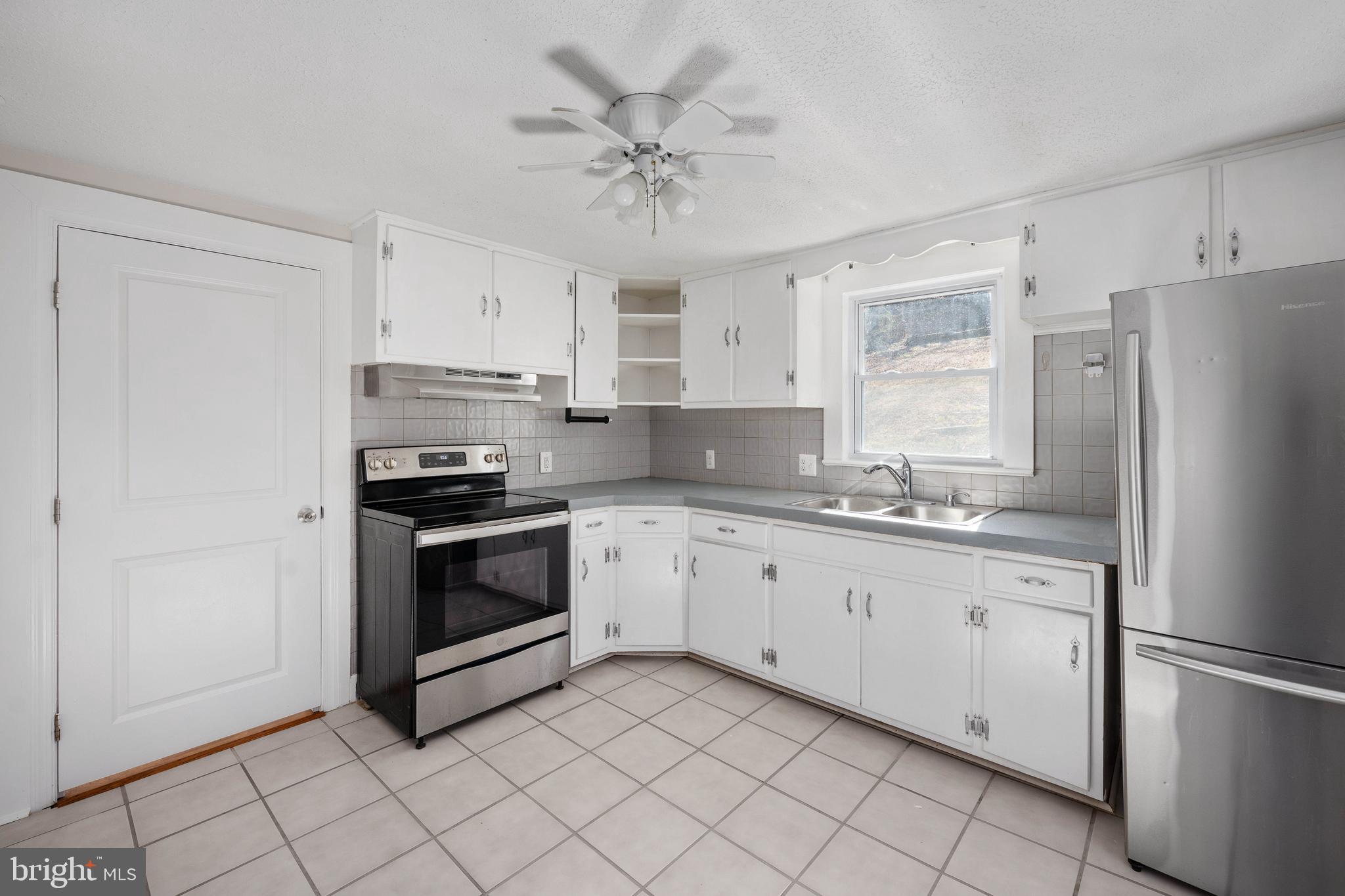 246 Berry Street Orange, VA 22960 - Photo 30 of 46 a kitchen with granite countertop white cabinets and white appliances