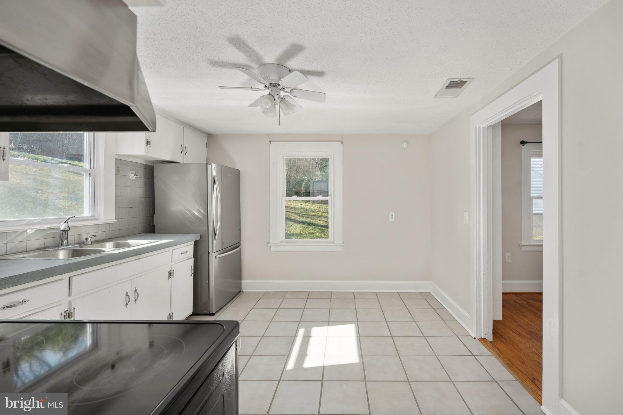 246 Berry Street Orange, VA 22960 - Photo 31 of 46 a large white kitchen with a sink a window and stainless steel appliances