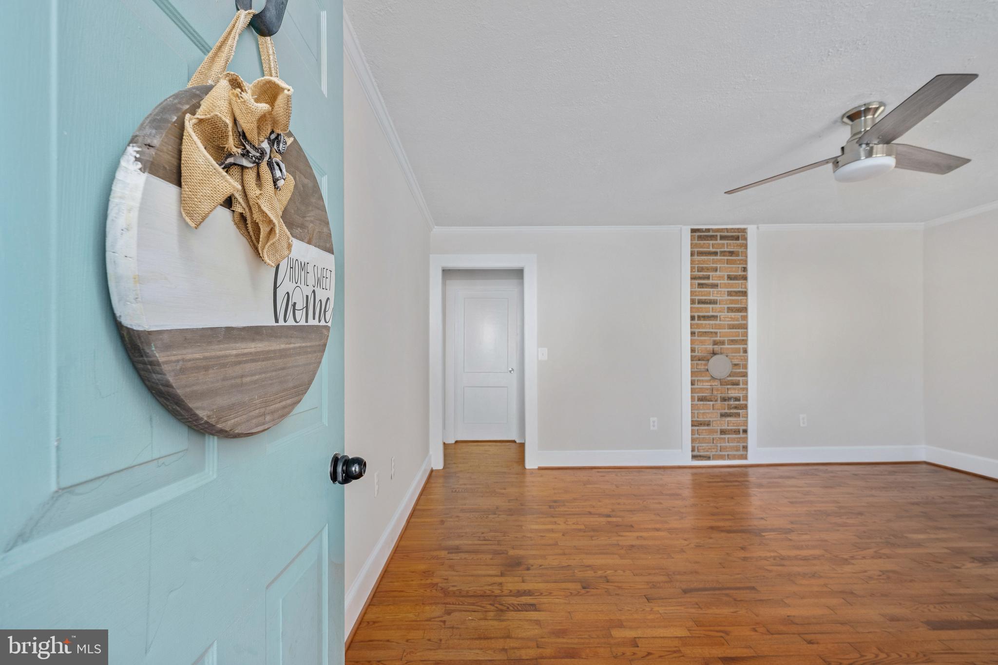 246 Berry Street Orange, VA 22960 - Photo 10 of 46 a view of a livingroom with wooden floor and a potted plant