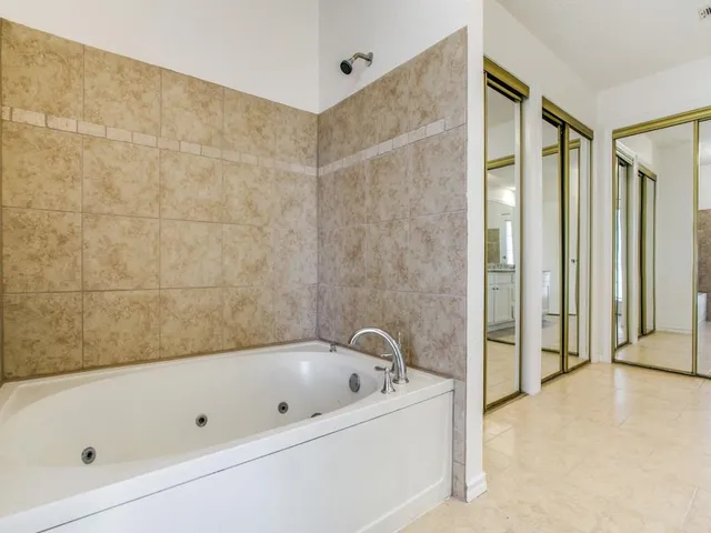 a bathroom with a bathtub and shower