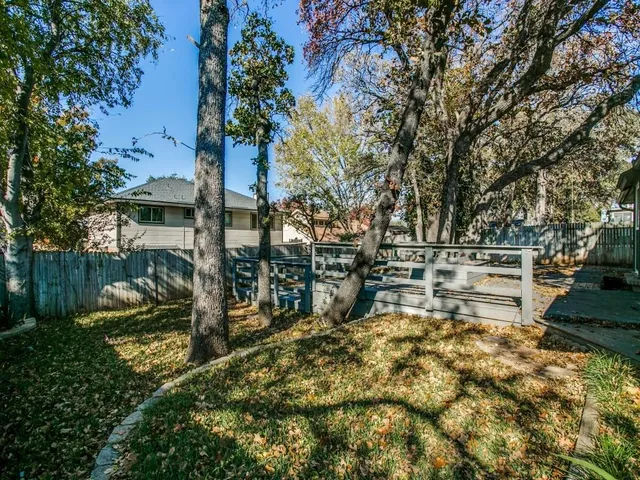a view of yard with swimming pool and trees