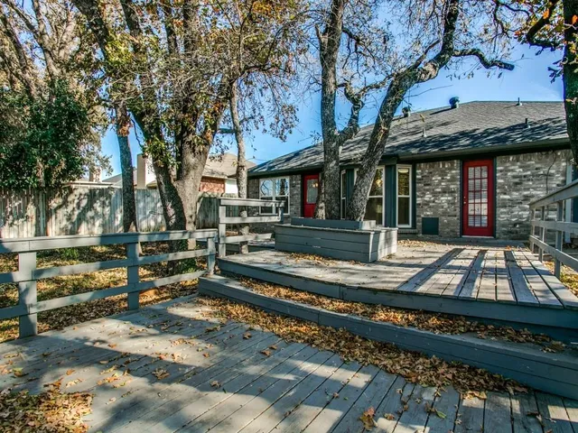 a view of a yard with wooden fence