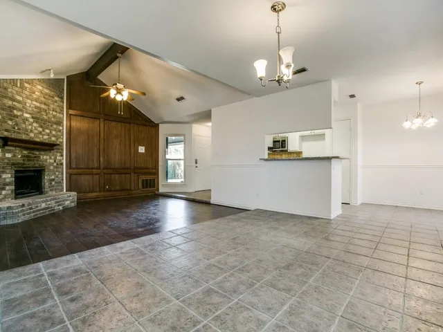 a view of a kitchen with a sink and a fireplace