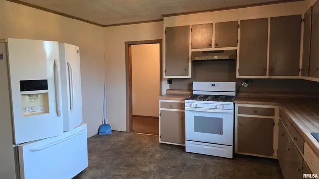 a kitchen with a stove and a refrigerator