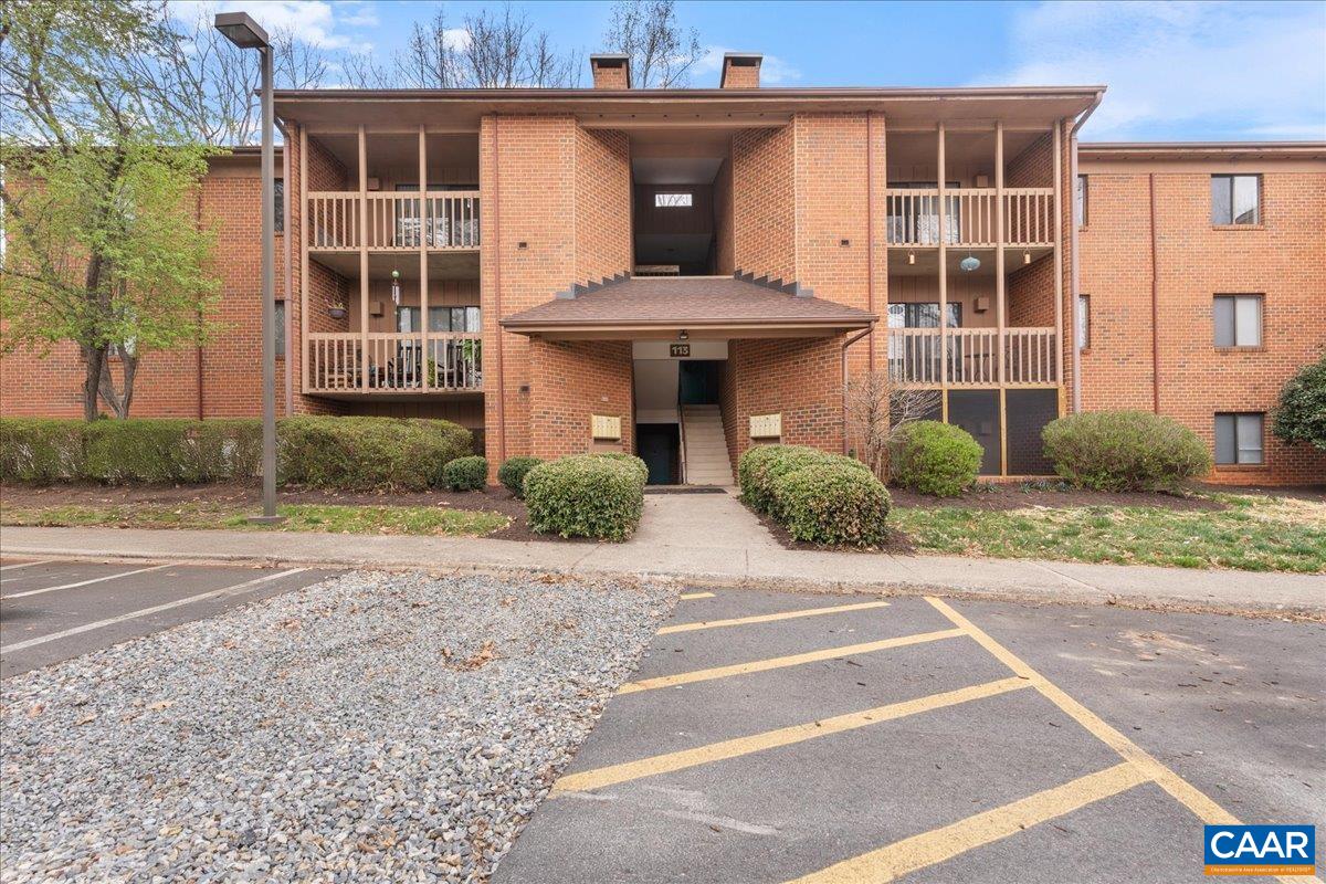 a front view of a house with glass windows and plants