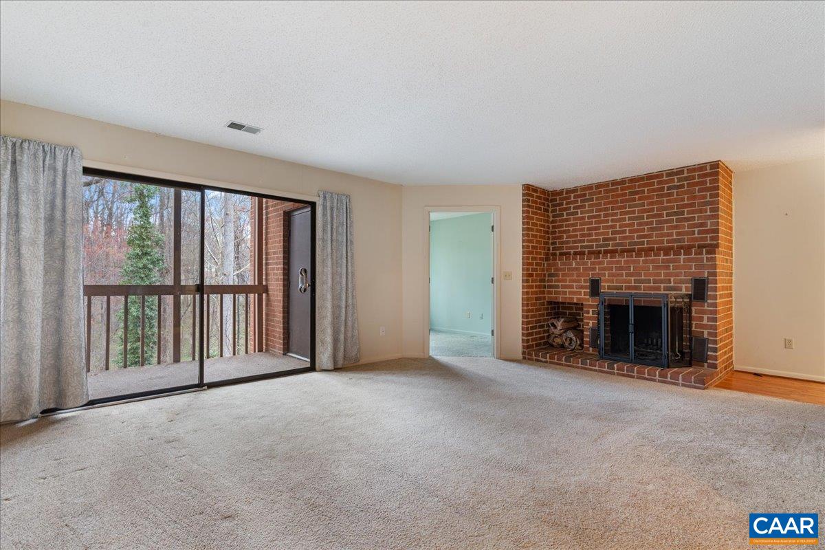 113 Turtle Creek Road, Unit 6 Charlottesville, VA 22901 - Photo 11 of 33 a view of an empty room with a fireplace and a window