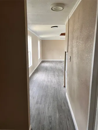 a view of hallway with wooden floor