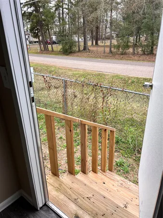 a view of balcony with wooden floor and fence