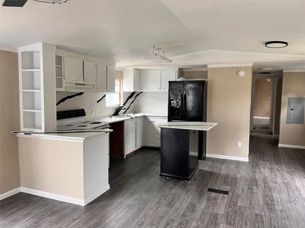 a kitchen with a sink appliances and cabinets