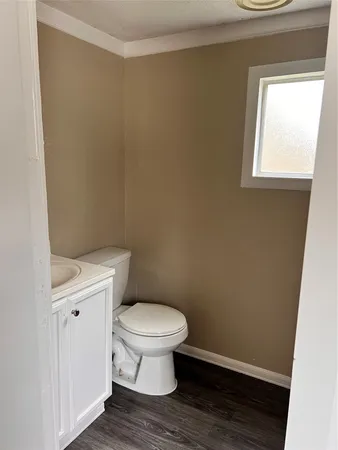 a bathroom with a toilet and a window