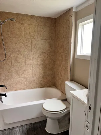 a bathroom with a toilet and a bathtub