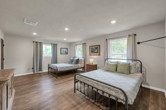 a bedroom with a bed and a couch