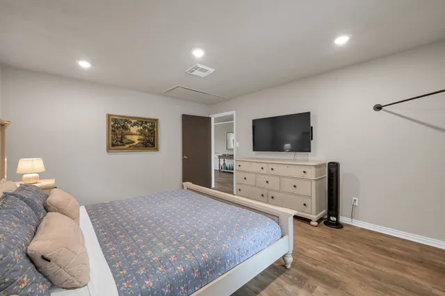 a bedroom with a bed and a flat screen tv