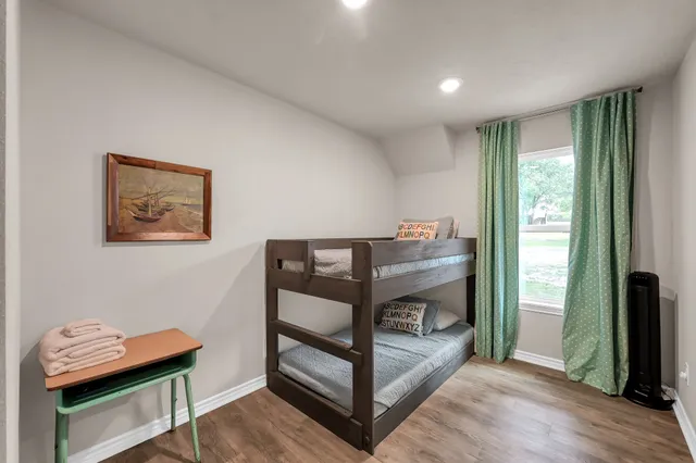 a bedroom with furniture and a window