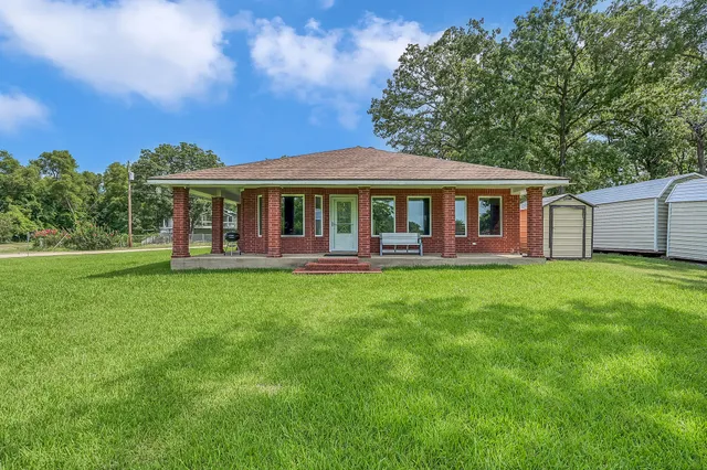 a front view of a house with a yard table and chairs