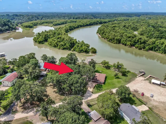 an aerial view of a house and lake view