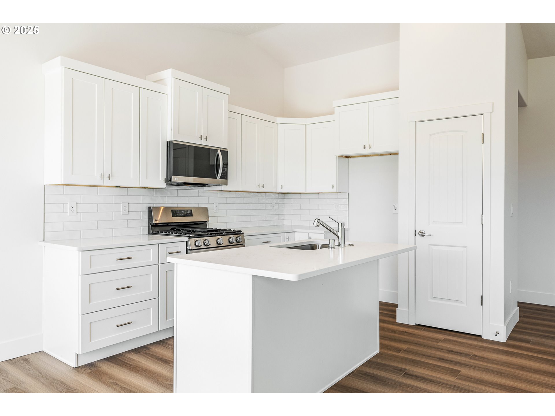 303 Sage Street Boardman, OR 97818 - Photo 13 of 25 a kitchen with stainless steel appliances a stove microwave and cabinets