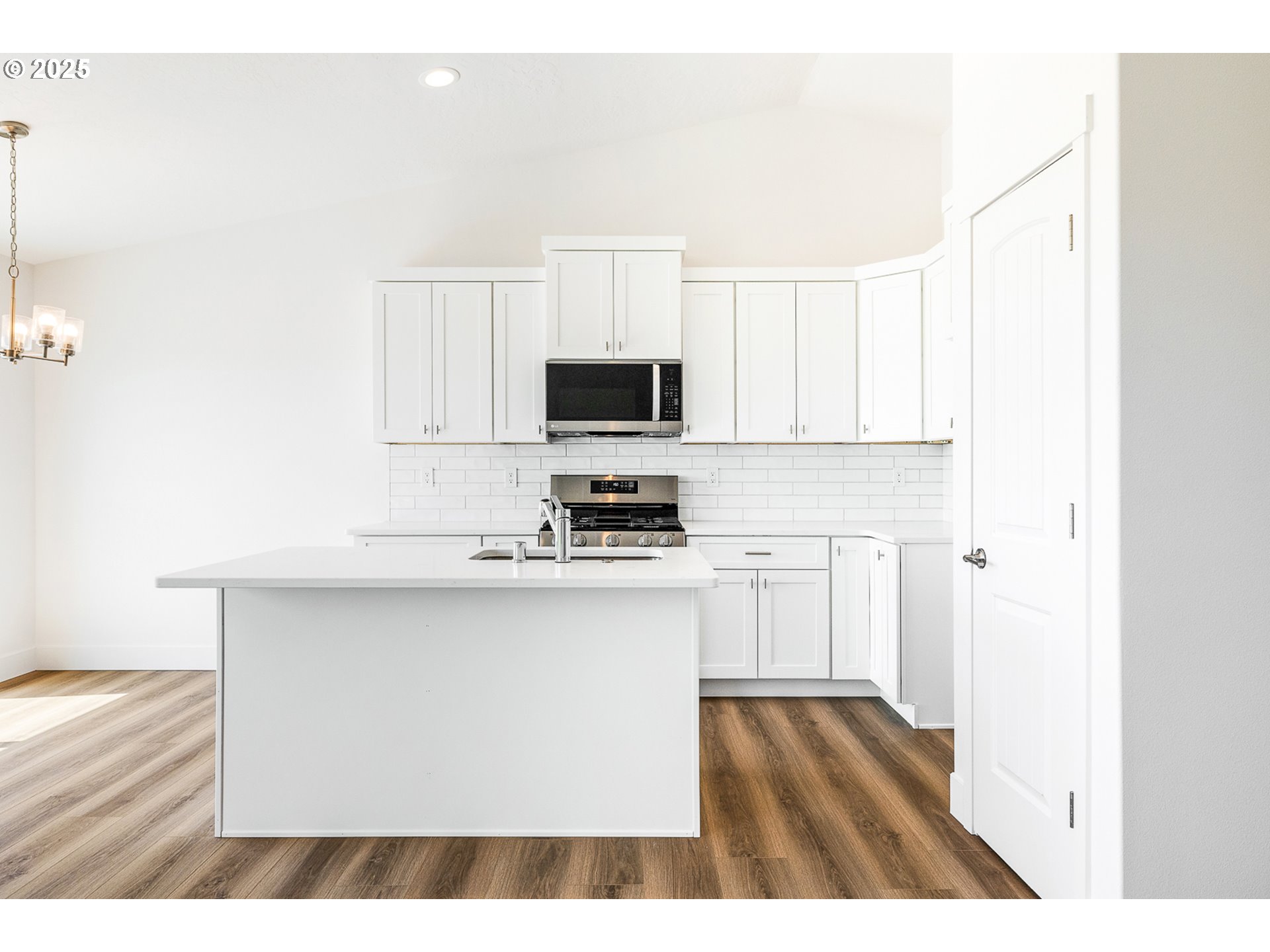 303 Sage Street Boardman, OR 97818 - Photo 14 of 25 a kitchen with stainless steel appliances a stove top oven a sink and a refrigerator